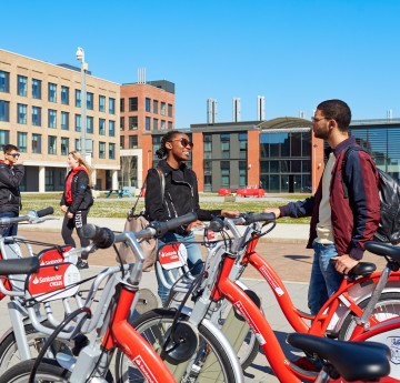 Students using the Santander bikes on Bay Campus